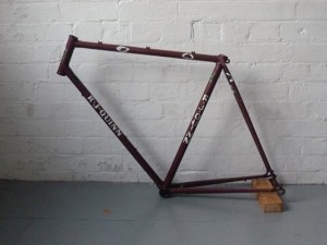 The stripped frame (with circled dents) ready for refurbishment